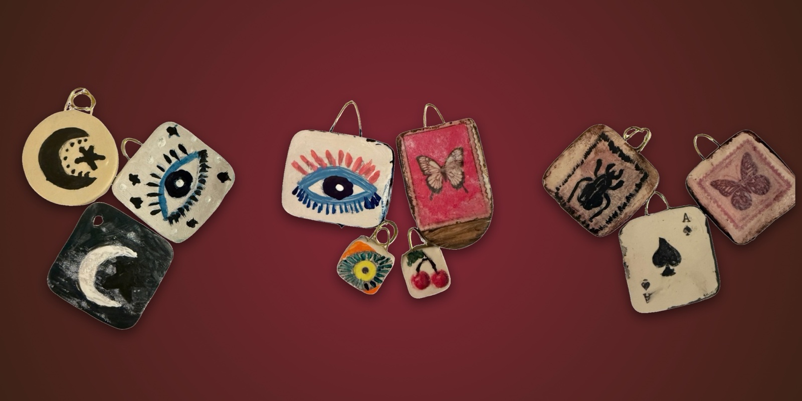 Hand-painted clay love charms with moons, eyes, a butterfly, cherries, a beetle and an ace, made at Amor Mágico, a couples craft night in Los Angeles